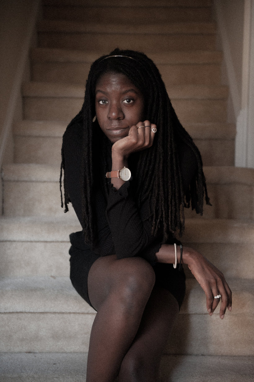 King Anne, singer-songwriter, seated on a staircase